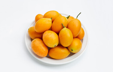 Marian plum fruit in white plate on white background.