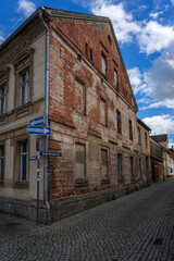 Streets and facade with street names and one-way traffic signs in old town. Juterbog is a historic town in north-eastern Germany, in the district of Brandenburg.