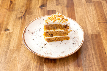 Three-tier carrot cake with its ice cream and walnuts on top