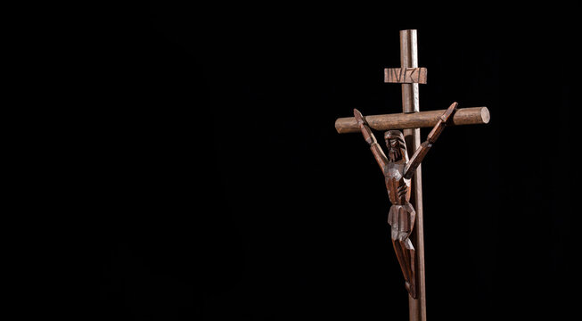 Catholic wooden cross, religious symbol - Black background