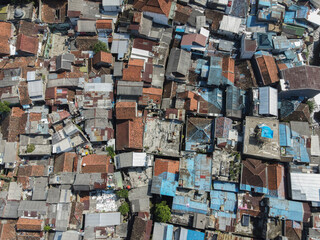 Aerial view of densely populated residential area in Bandung City, capital of West Java Province, Indonesia. Crowding of residential constructions in Asia.