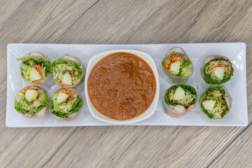 Overhead view of fresh rolls for that shrimp craving wrapped tight and served with dipping sauce