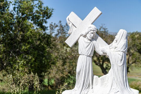 Santa Inez, CA, USA - April 3, 2009: San Lorenzo Seminary. Closeup of station of the cross number 6 in white marble statue with green background. Veronica wipes the face of Jesus