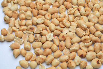 Roasted peanuts isolated on white background, clipping path, full depth of field. Selective focus
