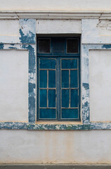 Fototapeta na wymiar Architectural heritage. Historic architecture. Blue window on white wall. Old building.