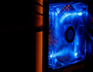 A modern desktop computer cooler spinning fast with blue RGB lighting and motion effect.