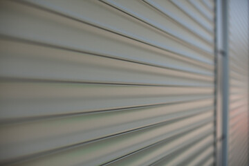 The surface of the blinds on the shop windows. Refracted plastic surface.
