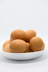 White plate with brown eggs