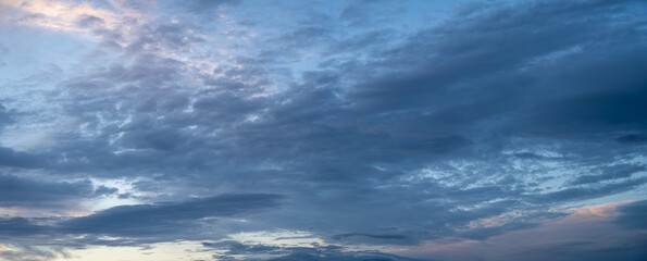 Naklejka na ściany i meble Panorama of only clouds at blue hour. Showing many shades of blue. 