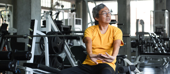 Elderly man exercising in the gym