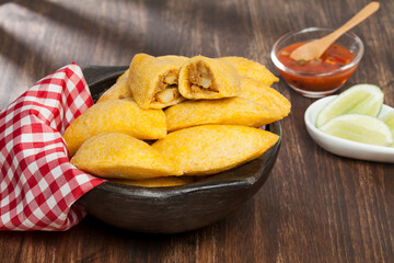 Tasty empanadas - Colombian cuisine; photo on wooden background