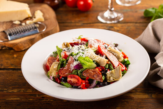 Italian antipasto salad with salami, artichoke hearts and olives