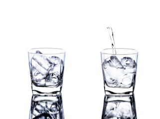 Two glasses of water with ice and poured water into the glasses. isolated on a white background