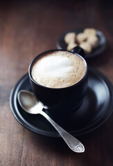 Coffee with milk on dark wooden background. Close up.	