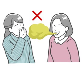口臭がきつい若い女性と鼻をつまむ若い女性