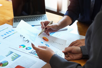 The company employee points to the document to calculate the budget and verify the correctness of...