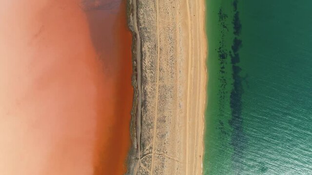 Flight forward beautiful Crimea Koyashskoe pink salt lake coastline black sea strip of land contrast.  Kerch Peninsula Russia travel landmark. Algae blooming. National park reserve. Summer. Horizon