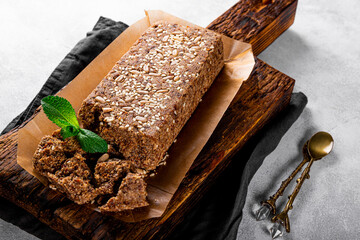  Healthy Vegan Sweets, Sugar Free Nuts Halva with Seeds and Sesame on a wooden cutting board close up