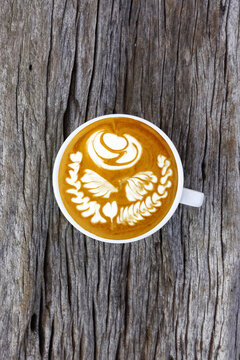 a cup of latte art coffee on wooden background                                         