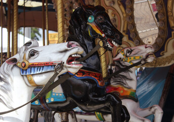 Fototapeta na wymiar Vintage Carousel horses at rural carnival or fair