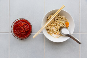 Fototapeta premium spicy instant noodles with egg and kimchi - korean food style