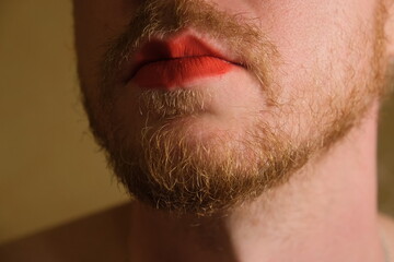 Obraz premium A gender fluid gay man with red lip stick