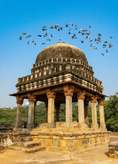 Old Mughal architecture located in Mehrauli archaeological park- New Delhi- India. Pigeons taking...