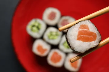 Fototapete Rund Chopsticks with tasty sushi roll, top view © Pixel-Shot