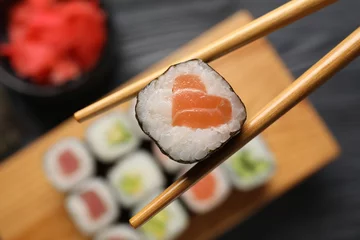 Fotobehang Chopsticks with tasty sushi roll, top view © Pixel-Shot