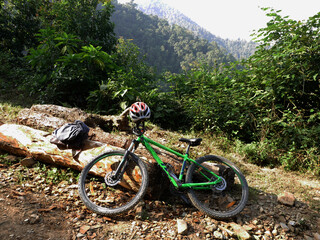 Nepali people or foreign travelers riding biking mountain bike or MTB and stop rest on gravel...