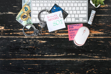 Composition with PC keyboard, money, handcuffs and credit card on wooden background. Hacking concept
