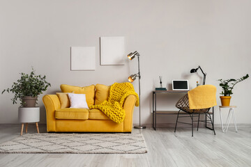 Interior of stylish living room with glowing lamps and comfortable workplace