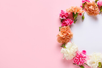 Fototapeta na wymiar Frame made of beautiful carnation flowers on color background