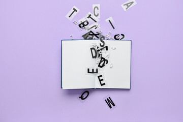 Blank book with letters on color background