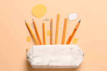 Pencil case and stationery on color background