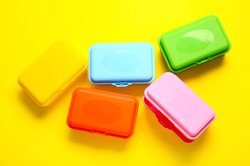Plastic lunch boxes on color background