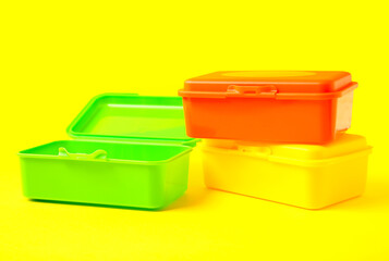 Plastic lunch boxes on color background