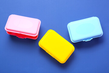 Plastic lunch boxes on color background