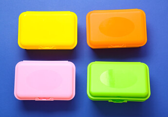 Plastic lunch boxes on color background