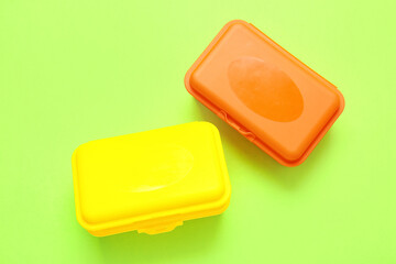 Plastic lunch boxes on color background