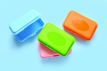 Plastic lunch boxes on color background