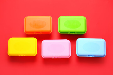 Plastic lunch boxes on color background