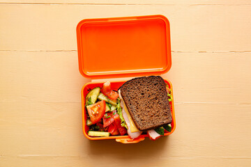 Lunch box with tasty food on color background