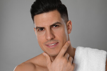 Handsome man after shaving on grey background, closeup