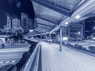 Modern pedestrian walkway in downtown of Hong Kong city at night