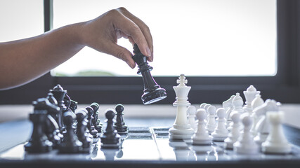 Businesswoman holding chess to take down opposing players, Proactive business planning and...