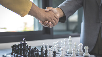 Business woman shaking hands, Hold hands to build business friendships after the chess game is...