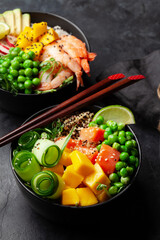Poke bowls with shrimps, salmon, avocado and mango
