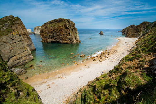 Coastal landscape with giant rocks on an unspoiled beach in Asturias, Spain.