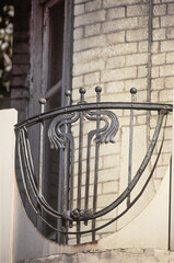 Old wrought iron balcony with decorative elements.
